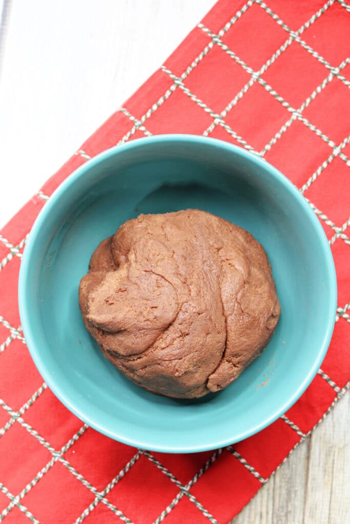 Santa's Cookies (Red Velvet Christmas Cookies) 5 Bowl with chocolate cookie dough on a red checkered cloth.