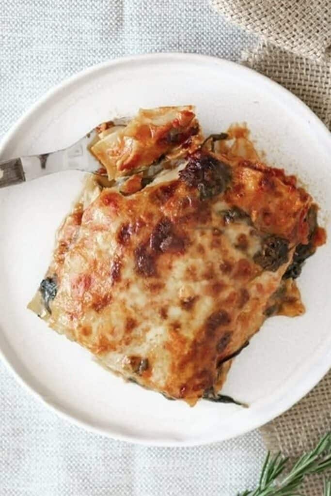 25 Venison Burger Casserole Recipes 4 Single serving of venison lasagna on a white plate.