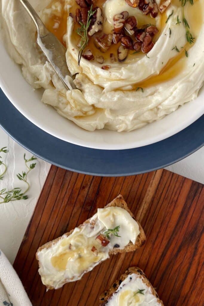 25 Christmas Appetizers That Travel Well 50 Overhead view of honey whipped goat cheese dip.