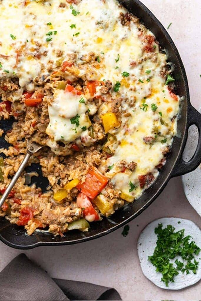 25 Venison Burger Casserole Recipes 27 Stuffed pepper casserole with metal serving spoon.