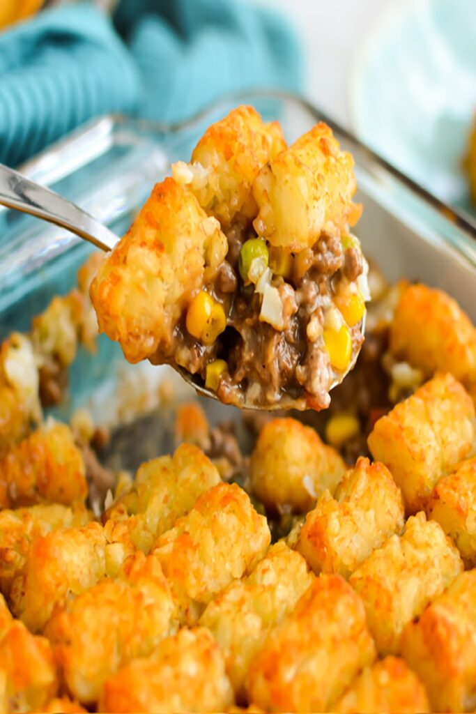 25 Venison Burger Casserole Recipes 23 Venison Burger casserole recipe with tater tots in a glass casserole dish and metal serving spoon.