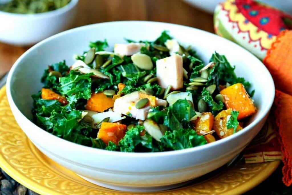 Side Dishes That Go With Venison (25+ Delicious Choices) 3 Autumn Salad With Butternut Squash Turkey And Kale in a white serving bowl.