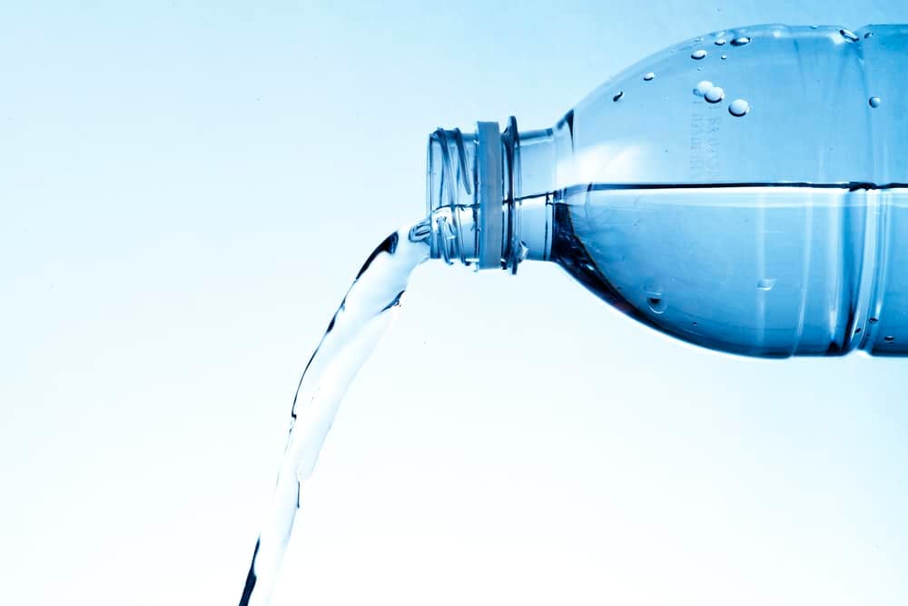What Is Distilled Water Used For? 20 Important Uses For Distilled Water 4 Distilled water in bottle pouring out.