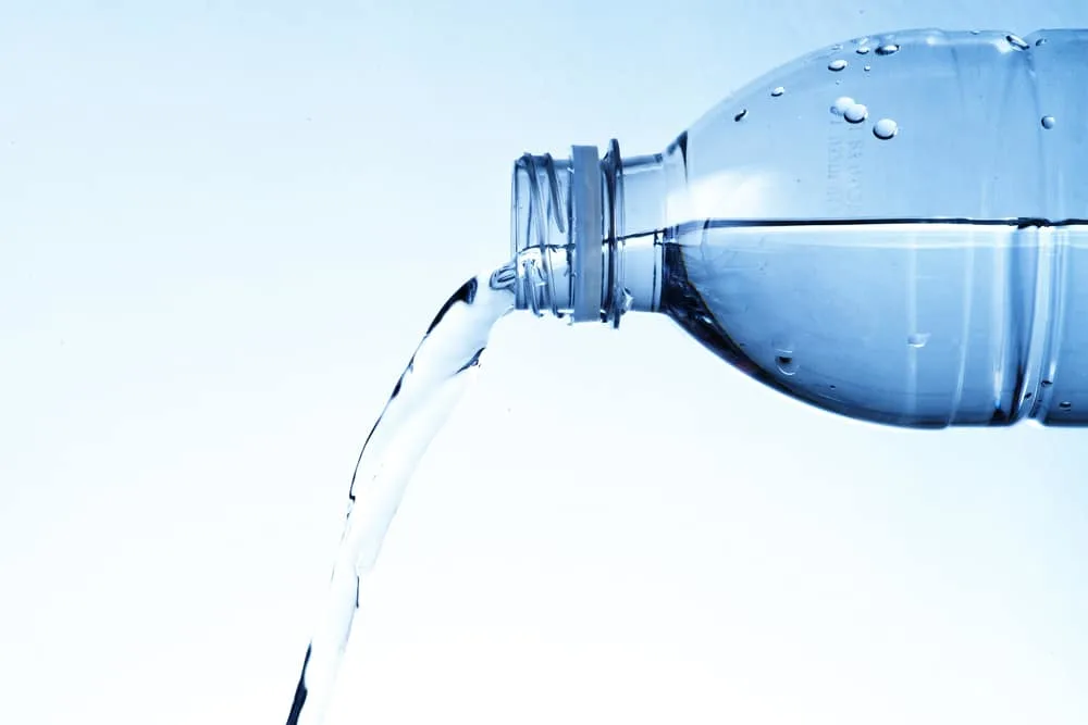 What Is Distilled Water Used For? 20 Important Uses For Distilled Water 4 Distilled water in bottle pouring out.