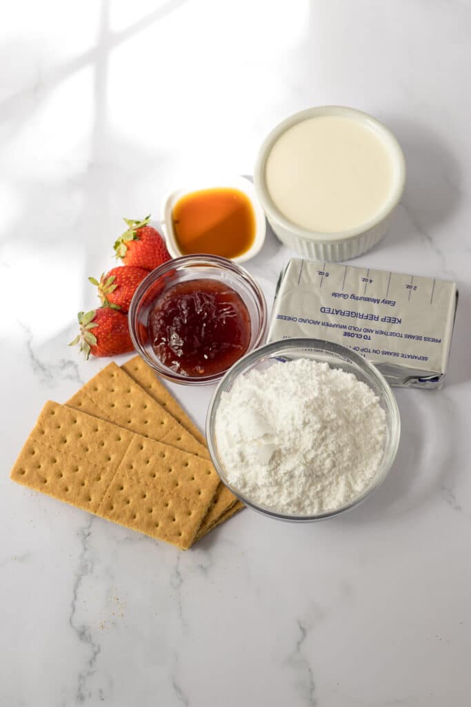 Easy Strawberry Icebox Cake 5 Strawberry Ice Box Cake ingredients on marble background