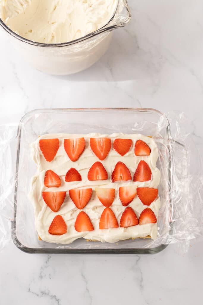 Easy Strawberry Icebox Cake 10 First layer of strawberry ice box cake in glass dish