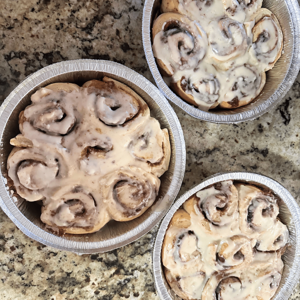 Mini Sourdough Cinnamon Rolls 3 small round pans of mini sourdough cinnamon rolls.