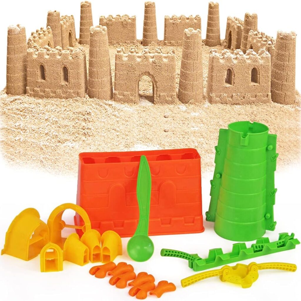 A colorful sand building kit in different colors with a sand castle behind it. 