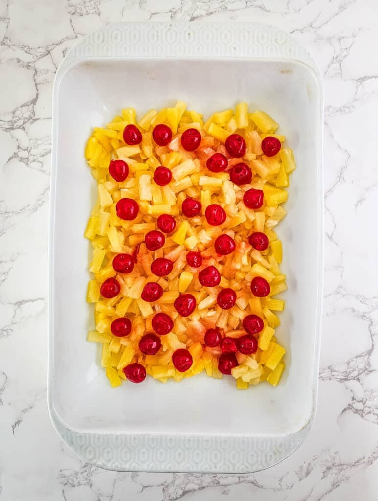 Pineapple Upside Down Dump Cake 5 pineapple and cherries in baking dish