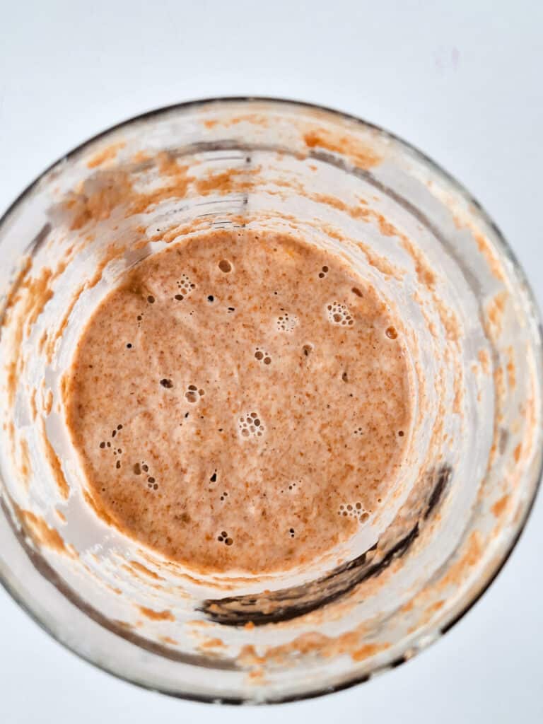 overhead view of sourdough starter in clear jar