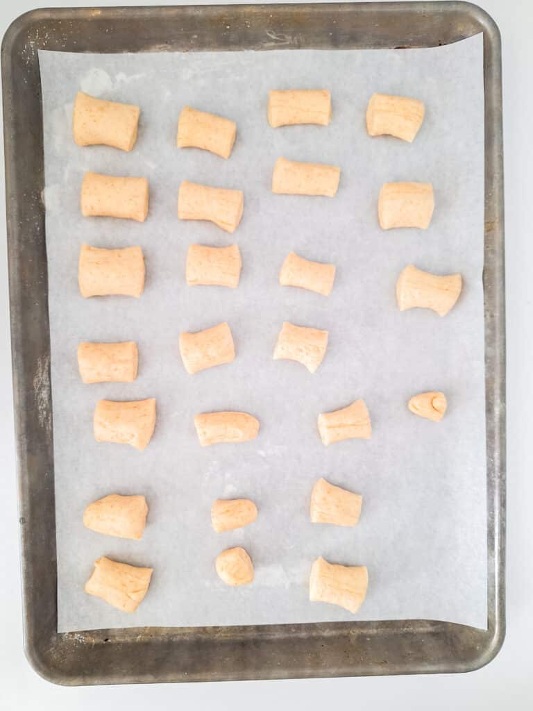 Sourdough Discard Pretzels 13 pieces of sourdough dough in circle form on parchment paper lined baking sheet