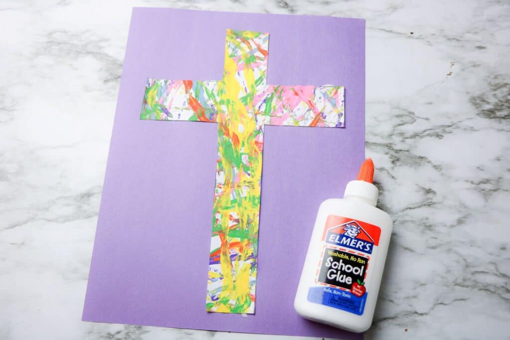 Cross Marble Painting Craft for Kids 22 The finished Cross Marble Painting craft pasted unto a purple construction paper.