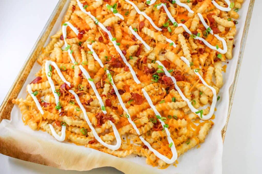 Loaded French Fries With Bacon 28 High-angle shot of the finished Loaded French Fries With Bacon on a sheet pan lined with parchment paper.