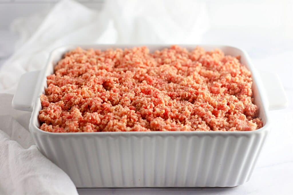 Strawberry Shortcake Crunch Bars with Box Cake Mix 6 A tray of the finished Easy Strawberry Crunch Cake Bars on a white surface.