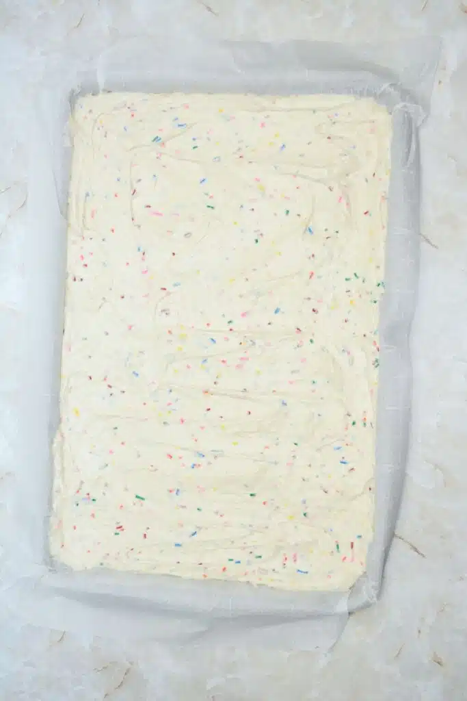 Easy From Scratch Confetti Birthday Cake Roll Recipe with Cream Cheese Frosting 17 Flat lay shot of the prepared jelly roll tray with the Funfetti cake batter spread out evenly across it.
