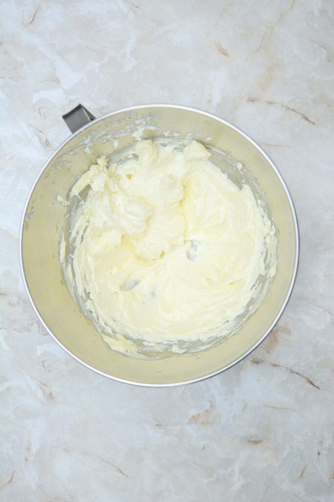 Flat lay shot of a mixing bowl with whipped sugar and butter in it. 
