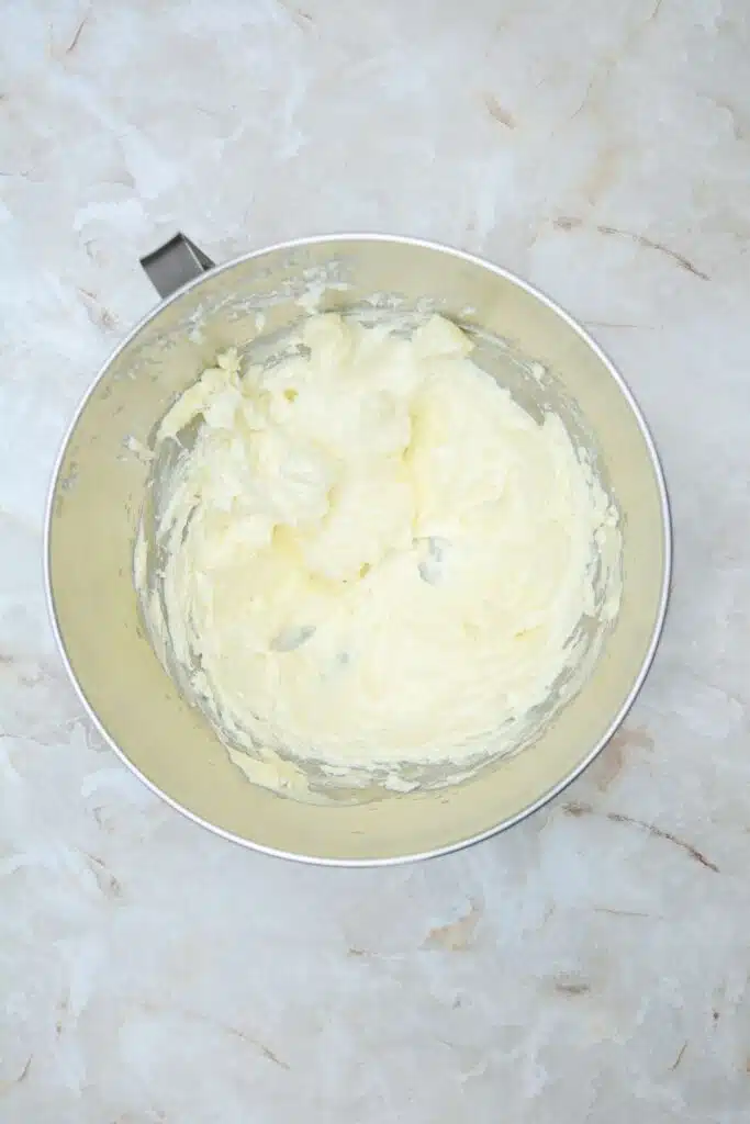 Easy From Scratch Confetti Birthday Cake Roll Recipe with Cream Cheese Frosting 13 Flat lay shot of a mixing bowl with whipped sugar and butter in it.