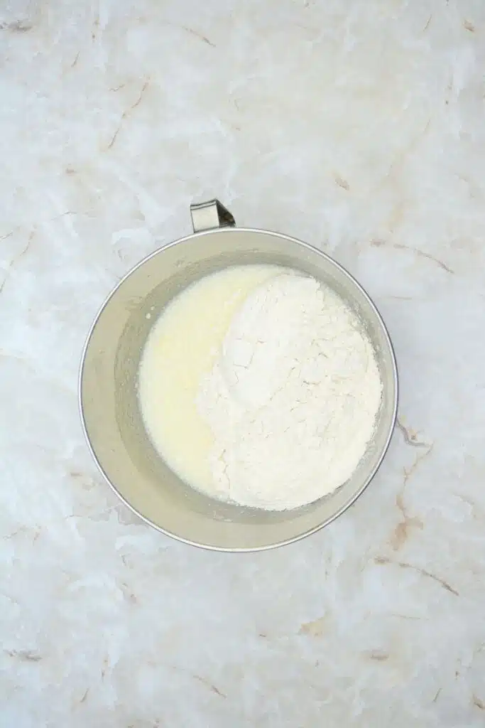 Easy From Scratch Confetti Birthday Cake Roll Recipe with Cream Cheese Frosting 15 Flat lay shot of a mixing bowl with whipped sugar, butter, eggs and flour.