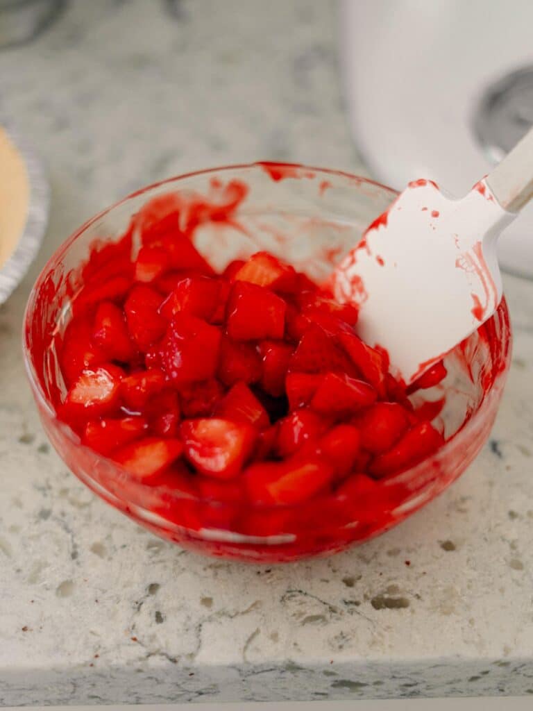 Best No-Bake Strawberry Cream Cheese Pie 12 A glass bowl with glazed strawberries in it.