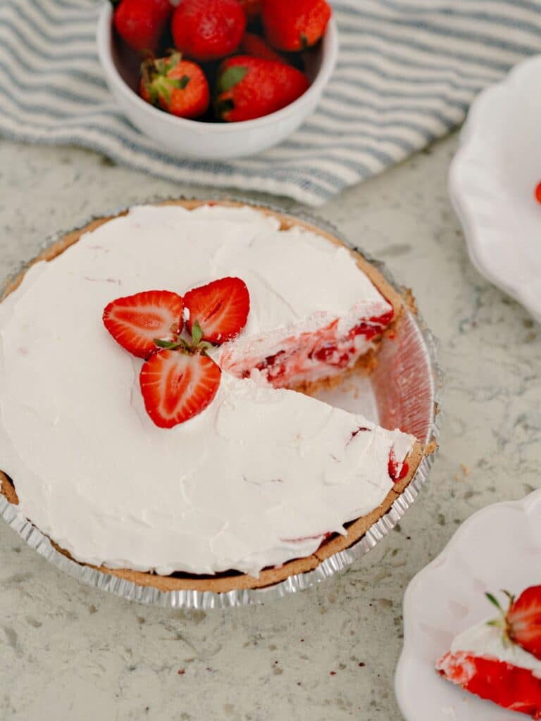 Best No-Bake Strawberry Cream Cheese Pie 17 High angle shot of The Best No-Bake Strawberry Cream Cheese Pie with a slice taken out of the dish.