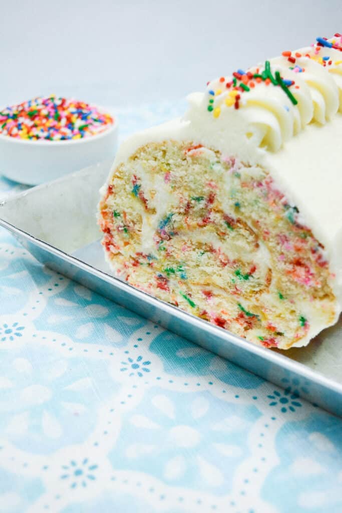 A Confetti Cake Roll in a stainless steel platter.