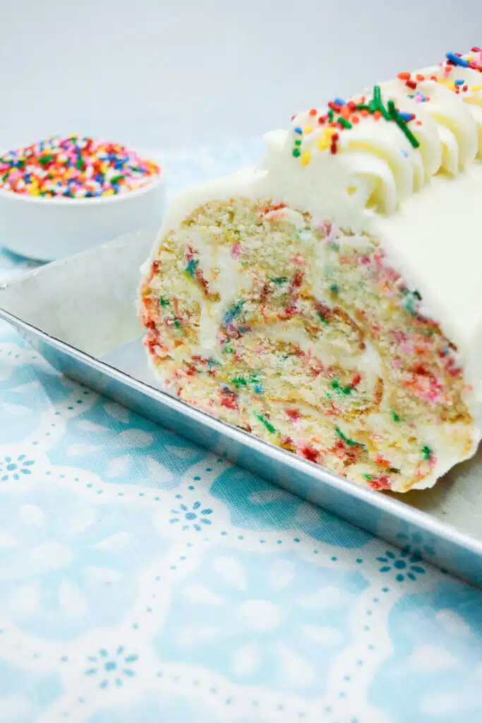 Easy From Scratch Confetti Birthday Cake Roll Recipe with Cream Cheese Frosting 35 A Confetti Cake Roll in a stainless steel platter.