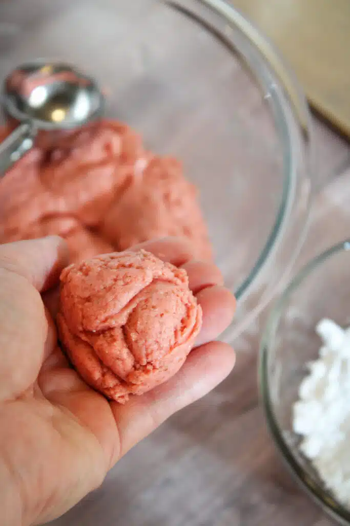 The Easiest Strawberry Cake Mix Crinkle Cookies (4 Ingredients + Vegan!) 10 Rolled dough of strawberry cake mix cookie dough