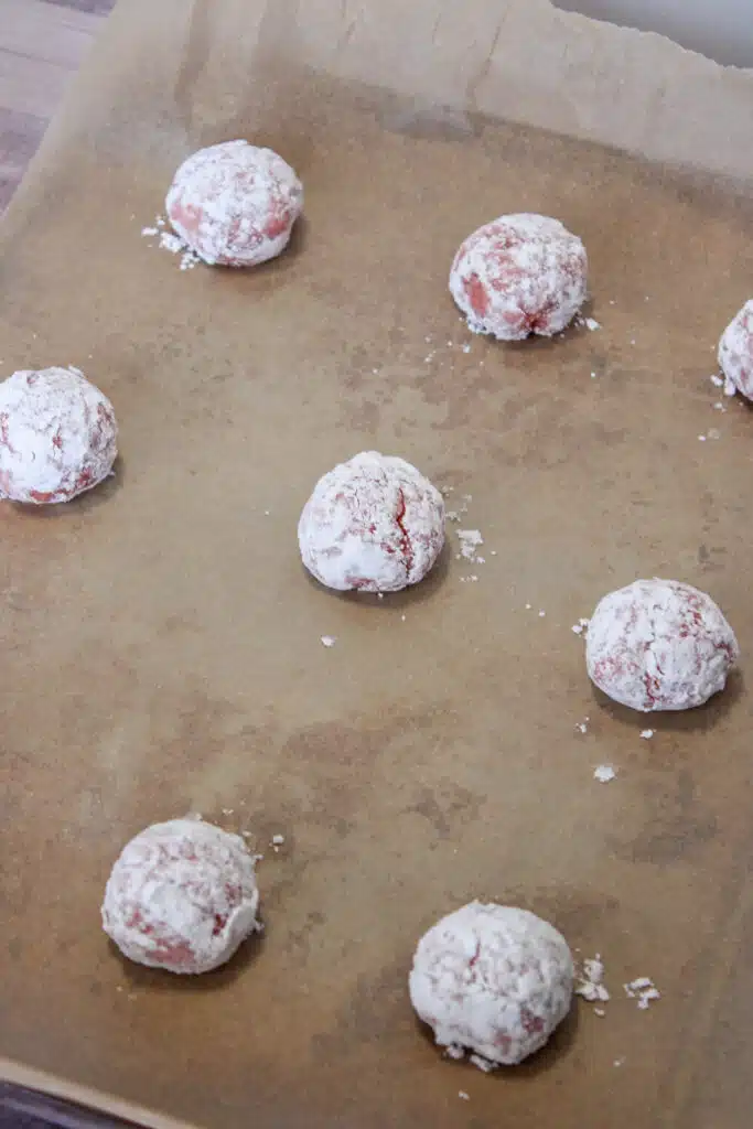 The Easiest Strawberry Cake Mix Crinkle Cookies (4 Ingredients + Vegan!) 13 strawberry crinkle cookies on parchment paper