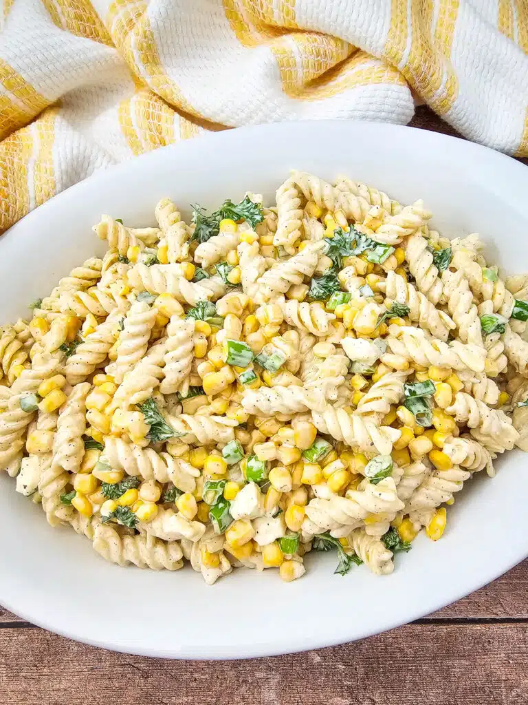 Flat lay shot of the Mouth-Watering Mexican Street Corn Pasta Salad on a white oval platter.