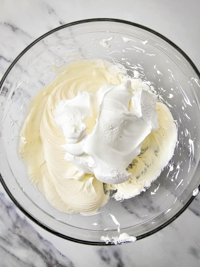 Easy 4-Ingredient Cherry Cheesecake Dip 8 Cool Whip added into the cream cheese mixture in a glass bowl.
