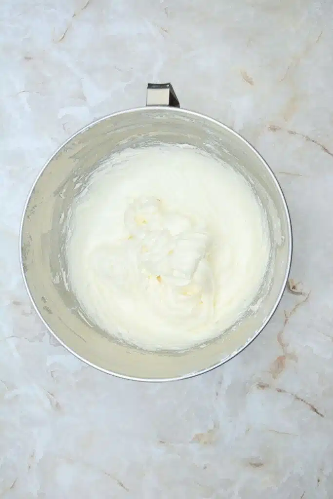 Easy From Scratch Confetti Birthday Cake Roll Recipe with Cream Cheese Frosting 24 Flat lay shot of a mixing bowl with the cream cheese frosting in it.