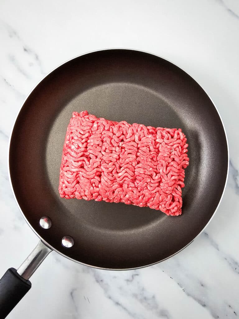Ground venison in a skillet.