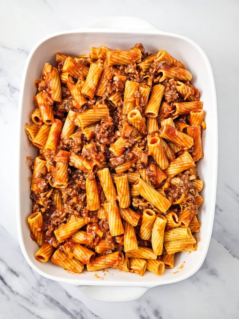 Flat lay of a white baking dish with the pasta dish in it.