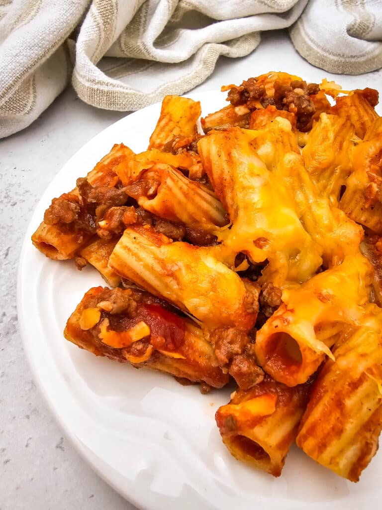 Venison Sloppy Joe Casserole Recipe 3 Closeup shot of a serving of Easy and Family-Friendly Venison Sloppy Joe Casserole in a white plate.