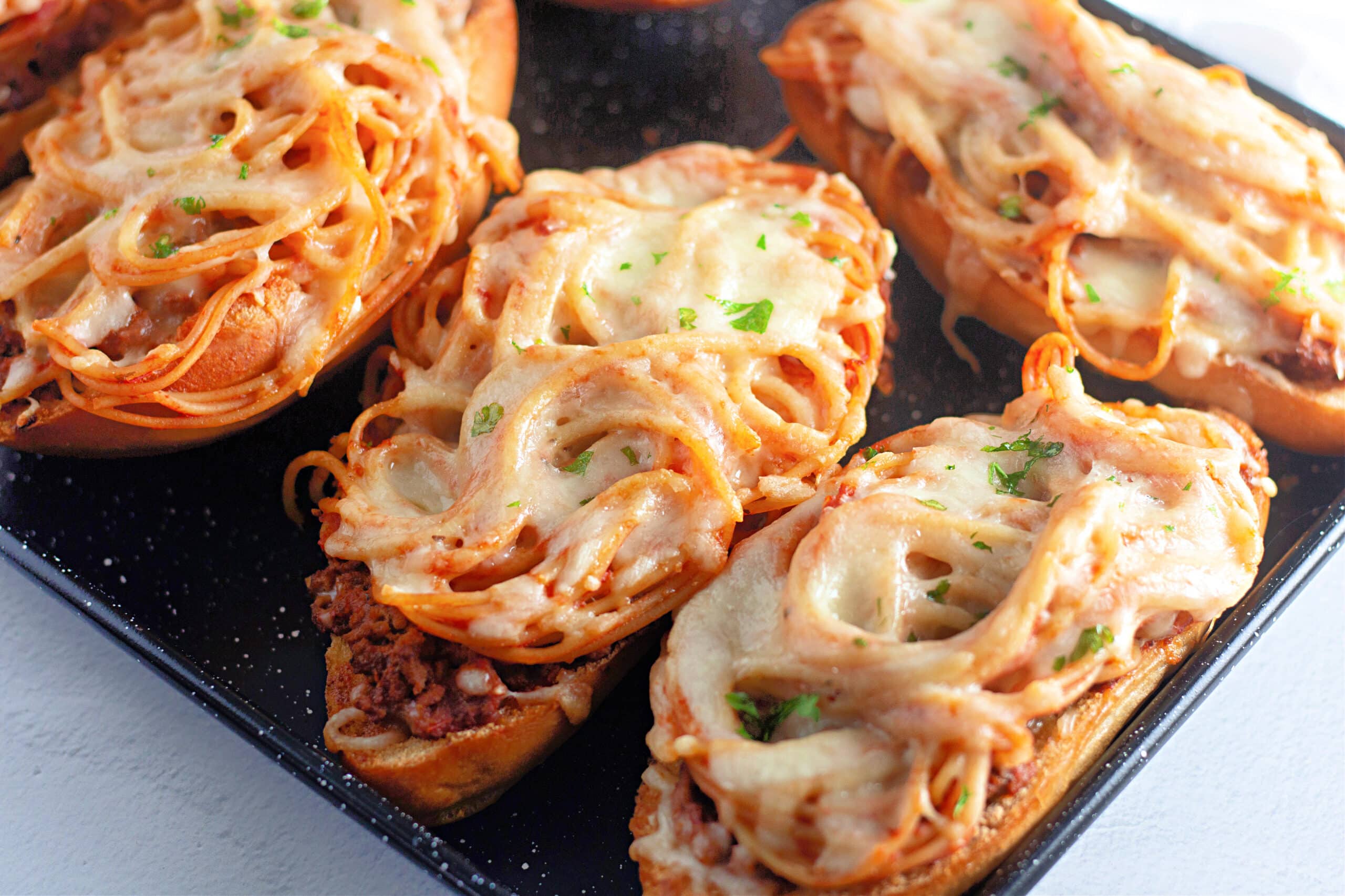 Four Venison Spaghetti Breads in a sheet tray.