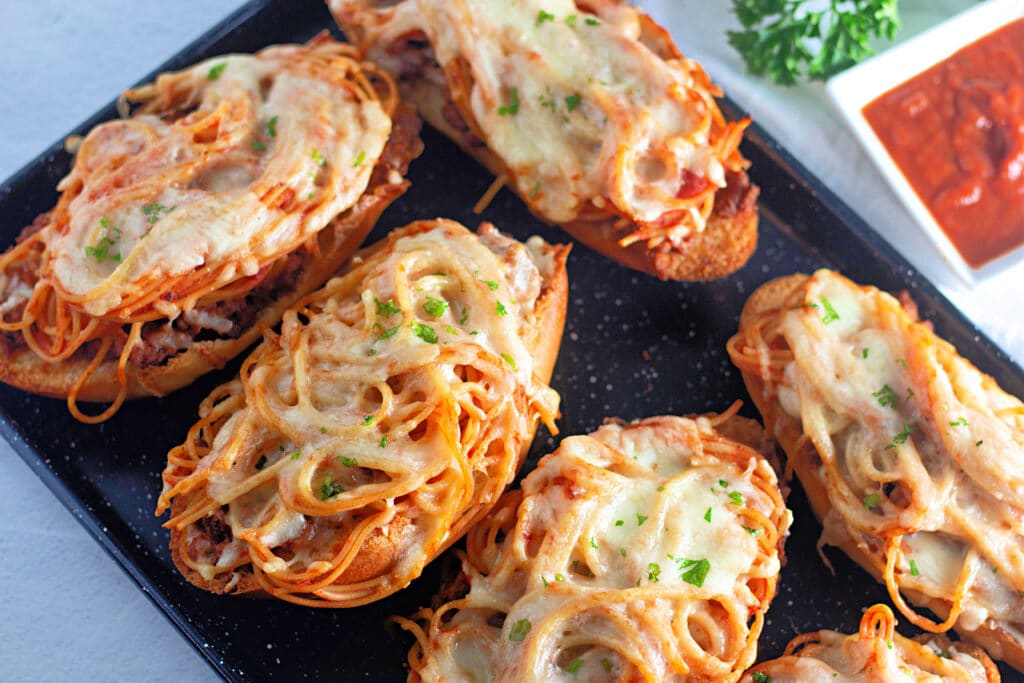 Venison Spaghetti Bread (A Family Favorite!) 2 Flat lay shot of five Venison Spaghetti Breads on a sheet tray