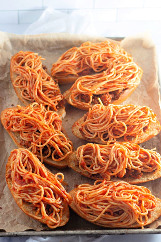Venison Spaghetti Bread (A Family Favorite!) 14 Eight half slices of Hoagie rolls topped with layers of meat sauce and spaghetti, then placed on a sheet tray.