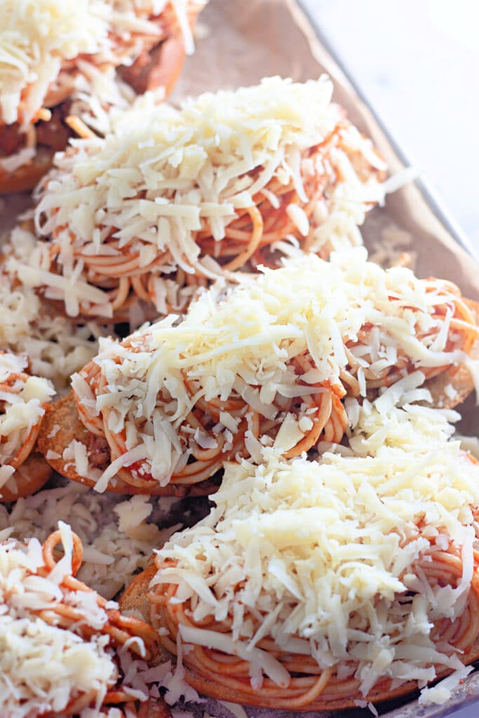 Venison Spaghetti Bread (A Family Favorite!) 17 Closeup shot of the Venison Spaghetti Breads topped with cheese, before baking in the oven.