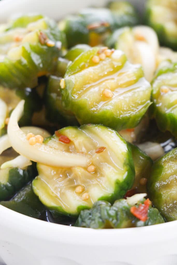 Closeup shot of a white bowl with Easy Refrigerator Bread and Butter Pickles.