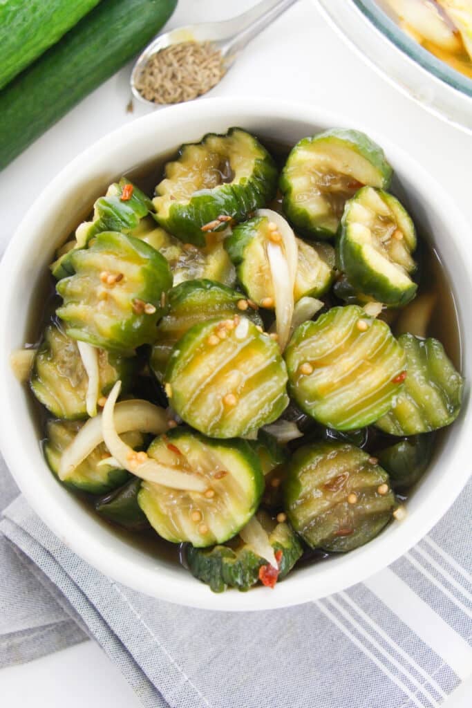 Easy Refrigerator Bread and Butter Pickles 18 A white bowl with pickles in it.