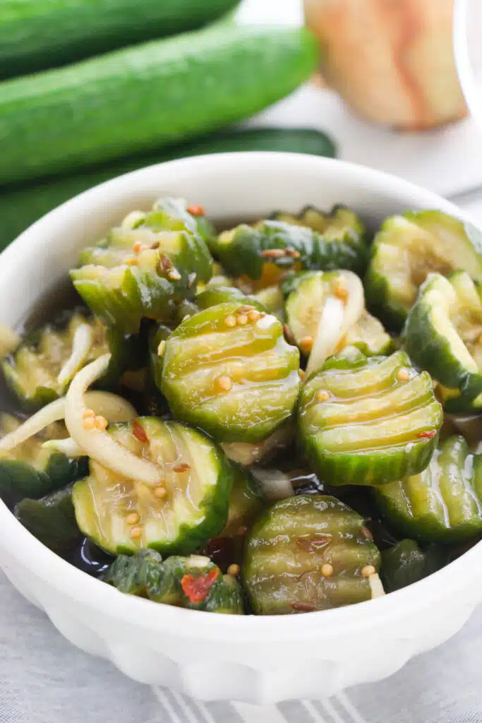 A white bowl with Easy Refrigerator Bread and Butter Pickles.