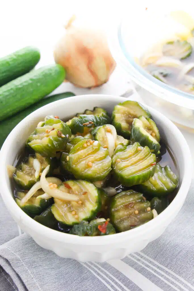 A white bowl with Easy Refrigerator Bread and Butter Pickles.