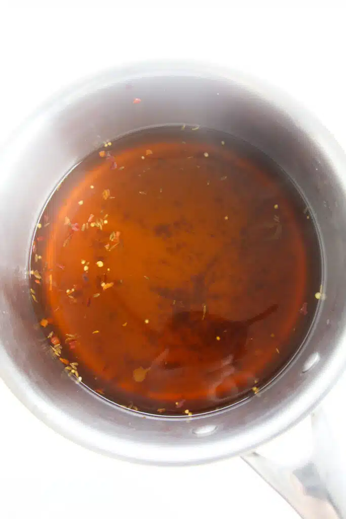 A vinegar mixture simmering in a small saucepan.